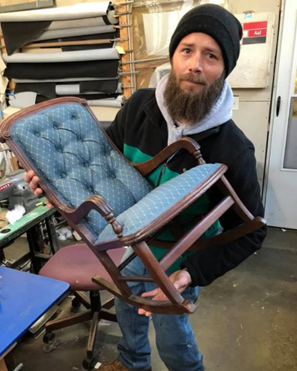 man holding chair